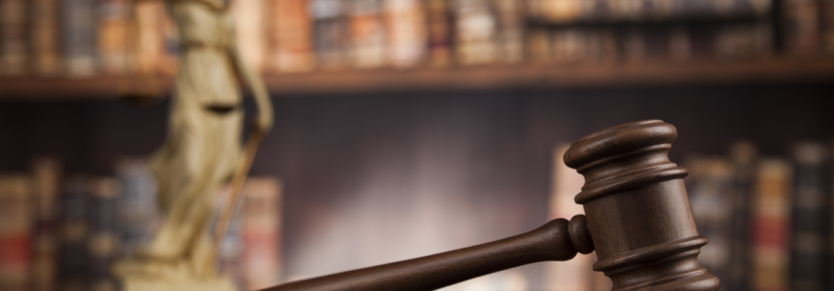 Law theme, mallet of the judge, wooden desk, books